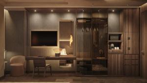 a room with a desk with a television and a chair at The Bank by MYR Hotels in Valencia