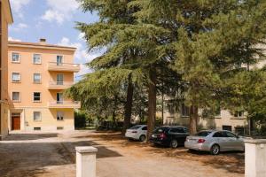 a group of cars parked in front of a building at B&B La Littorina - Parcheggio Privato in Foligno