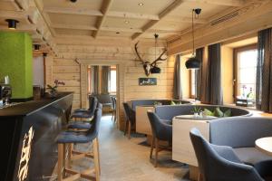 a restaurant with a row of chairs and tables at Hotel Weiler - Aktiv & Tradition in Obertilliach