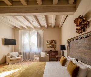 a bedroom with a large bed and a large window at Hotel Finca El Peregrino in Puente la Reina
