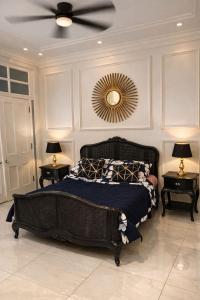 a bedroom with a bed and a ceiling fan at Greystone Mansion in Accra