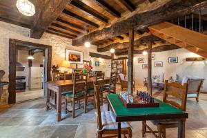 a kitchen and dining room with a table and chairs at La Maison de Yûka in Plieux