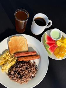 a plate of breakfast food with a cup of coffee at Guayacan Real Deluxe in Nicoya +11 photos
