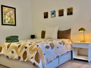 a bedroom with a bed and pictures on the wall at San Antonio Del Mar - Beachfront Studio for Two in San Antonio del Mar
