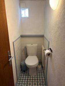 a small bathroom with a toilet with a black and white floor at Ferienidyll Cleebourg in Cleebourg +17 photos