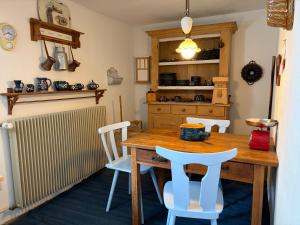 a dining room with a wooden table and chairs at Ferienidyll Cleebourg in Cleebourg