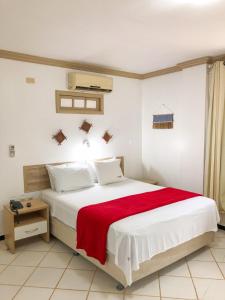 a bedroom with a large bed with a red blanket at Pousada do Mingote in Alter do Chao +31 photos