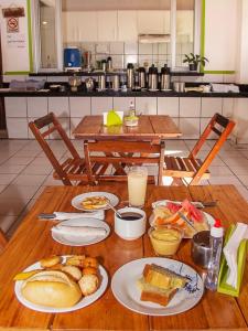a wooden table with plates of food on it at Pousada do Mingote in Alter do Chao