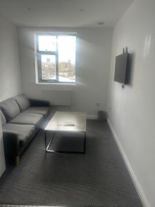 a living room with a couch and a table at The millstone residents in Bradford