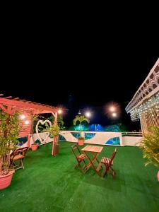 a patio with a table and chairs at night at Pousada do Mingote in Alter do Chao