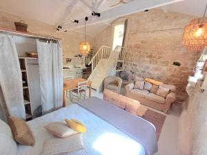 a bedroom with a bed and a living room at Moon in Flaugnac