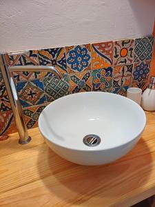 a white sink on top of a counter in a bathroom at Moon in Flaugnac +30 photos