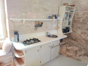 a kitchen with a sink and a counter top at Moon in Flaugnac