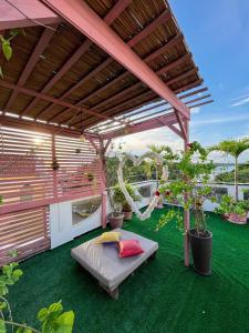 a patio with a bed and potted plants on the grass at Pousada do Mingote in Alter do Chao