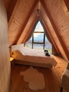 a bedroom with a bed in a wooden attic at Vila Ahouse in Jagodina +28 photos
