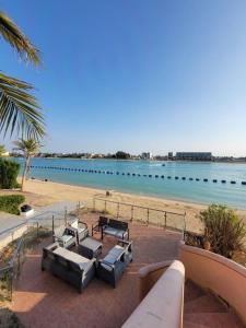 a beach with a group of chairs and a surfboard at LA Brisa Durrat Alarous شاليهات لابريزا درة العروس شاطئ البرادايس للعوائل فقط in Durat Alarous +17 photos