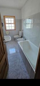 a bathroom with a tub and a sink and a toilet at M&L Gerês in Salamonde +24 photos