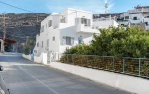 an empty street next to a white building at Katerina Irida in Mérikhas