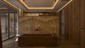 a large bathroom with a tub and a toilet at The Bank by MYR Hotels in Valencia +25 photos