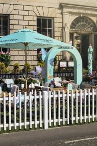 a white picket fence in front of a store at Tigerlily in Edinburgh