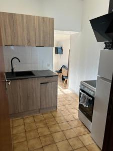 a kitchen with a sink and a stove at Studio Le Vale - Centre Ville de Givet in Givet