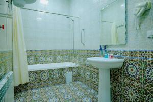 a bathroom with a sink and a shower and a toilet at Imperial Palace Bukhara in Bukhara +110 photos