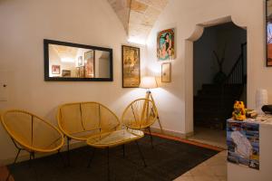 a living room with two chairs and a table at Moro Guest House in Lecce