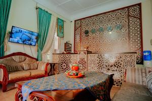 a living room with a table with a bowl of fruit on it at Imperial Palace Bukhara in Bukhara