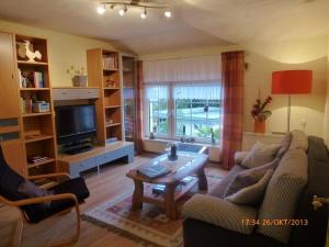 a living room with a couch and a coffee table at Ferienwohnung Ferien im Dorf in Bleckhausen