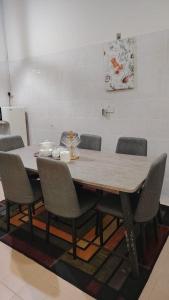 a wooden table and chairs in a room at MQ Homestay in Temerloh