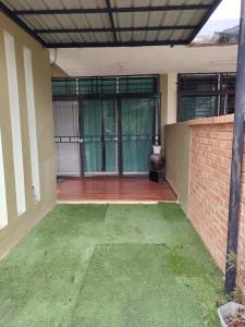 an outside view of a house with a patio at MQ Homestay in Temerloh