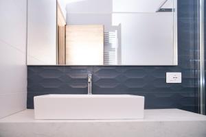 a bathroom with a white sink and a mirror at Tenuta Marella in Santa Maria di Galeria