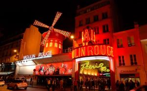a building with neon signs and a windmill on it at Hotel Royal Mansart in Paris