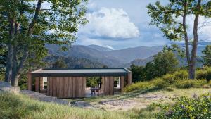 a house on a hill with a view of the mountains at L'Acciola in Evisa