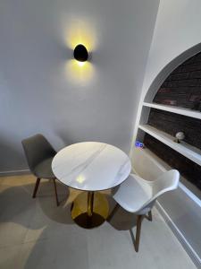 a white table and two chairs in a room at U&U place in Uyo