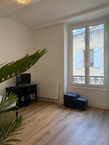 an empty living room with a desk and windows at Bastille in Tournon-sur-Rhône