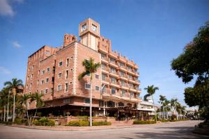 a building with a clock tower on top of it at Hotel Windsor Barranquilla in Barranquilla
