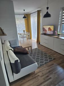 a living room with a bed and a dining room at Apartament M&G in Jarosław