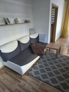 a living room with a couch and a table at Apartament M&G in Jarosław