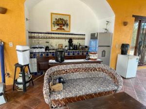 a kitchen with a couch in the middle of a room at Habitacion Sol in Puerto Escondido