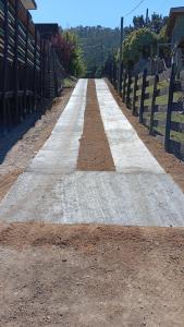 a long dirt road with a fence on the side at Lodge Los Bosques in Matanzas