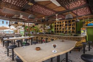 a restaurant with tables and chairs and a bar at Elysees Dream Beach Hotel-By AMARINA Hotels & Resorts in Hurghada