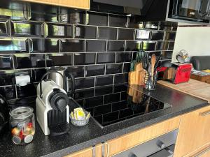 a kitchen counter top with a coffee maker on it at Le numéro 5 in Bar-le-Duc