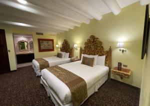 a hotel room with two beds and a mirror at Aranwa Sacred Valley Hotel & Wellness in Urubamba +46 photos
