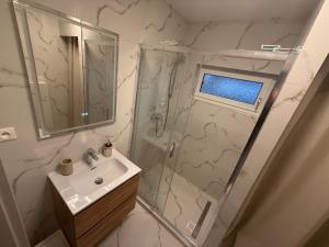 a white bathroom with a shower and a sink at Samaria Apartments in Šamorín +27 photos