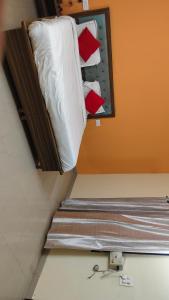 a bed with pillows on it in a room at Hotel R Himalayan in Mohali
