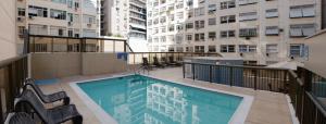 a balcony with a swimming pool and some buildings at Hotel Astoria Copacabana in Rio de Janeiro