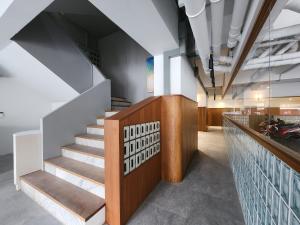 a staircase in a building with a stair case at Q Space Sathorn - Narathiwas 18 in Ban Nong Chaeng