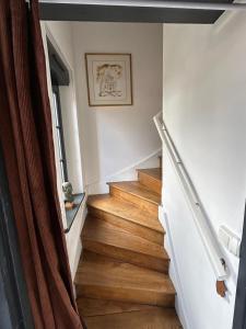 a staircase in a house with wooden floors at Le numéro 5 in Bar-le-Duc +15 photos