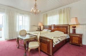 a bedroom with a large bed and a table and chairs at Nedre Berg Gard in Lillehammer